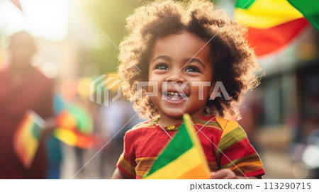Happy Child Holding red, green and yellow flag symbolizing Juneteenth Freedom and African liberation day. Black life matters. Black history month. 113290715