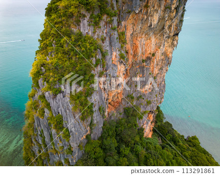 An aerial view of the Phra Nang beach of water surrounded by mountains An aerial view of the Phra Nang beach of water surrounded by mountains 113291861