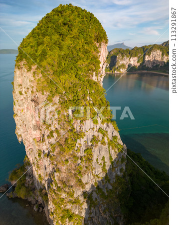 An aerial view of the Phra Nang beach of water surrounded by mountains 113291867