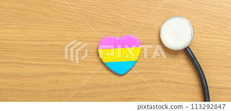Pansexual Pride Day and LGBT pride month concept. pink, yellow and blue heart shape with Stethoscope for Lesbian, Gay, Bisexual, Transgender, Queer and Pansexual community 113292847