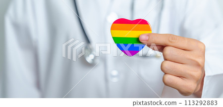 LGBT pride month or LGBTQ+ or LGBTQIA+ and health concept. Doctor with rainbow and colorful heart shape with for Lesbian, Gay, Bisexual, Transgender, Queer and Pansexual community LGBT pride month or LGBTQ+ or LGBTQIA+ and health concept. Doctor with rainbow and colorful heart shape with for Lesbian, Gay, Bisexual, Transgender, Queer and Pansexual community 113292883