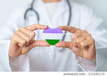 Queer Pride Day and LGBT pride month concept. Doctor hand holding purple, white and green heart shape with Stethoscope for Lesbian, Gay, Bisexual, Transgender, genderqueer and Pansexual community 113293173