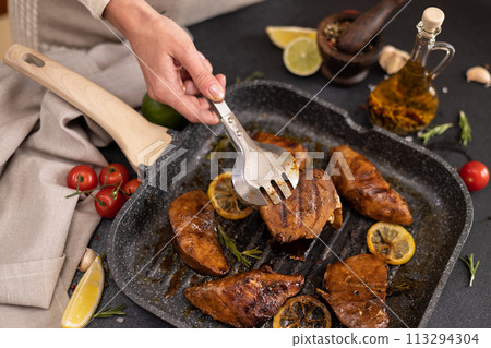 grilled pieces of Organic Tuna Steak on a grill frying pan 113294304