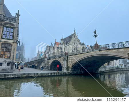 Ghent, Belgium. Old historic building near the river Leie on a foggy autumn day. Ghent, Belgium. Old historic building near the river Leie on a foggy autumn day. 113294457