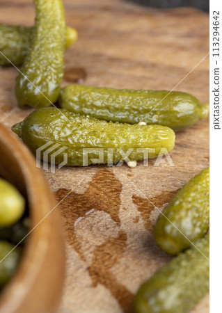 green pickled cucumbers on the table 113294642
