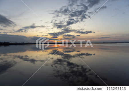 reflection of the sky in the lake at sunset reflection of the sky in the lake at sunset 113295113