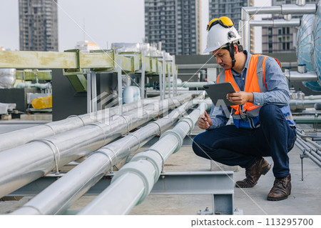 engineer male work checking water pipe inspecting valve testing water pump. 113295700