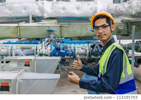 young engineer male in reflective vest is giving a thumbs up work pipe inspecting. good condition gas pipe young engineer male in reflective vest is giving a thumbs up work pipe inspecting. good condition gas pipe 113295703