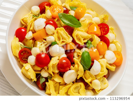 tortellini salad with tomatoes, mozzarella in bowl tortellini salad with tomatoes, mozzarella in bowl 113296954