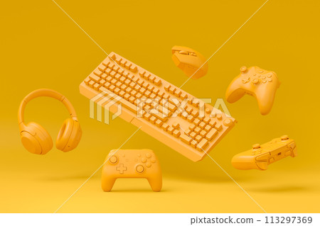 Modern home office setup featuring keyboard, gaming controllers and headphones 113297369