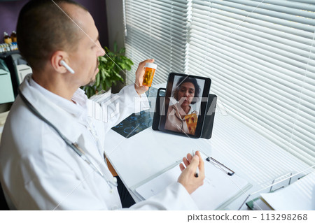 Doctor recommending patient medicine during telemedicine session Doctor recommending patient medicine during telemedicine session 113298268