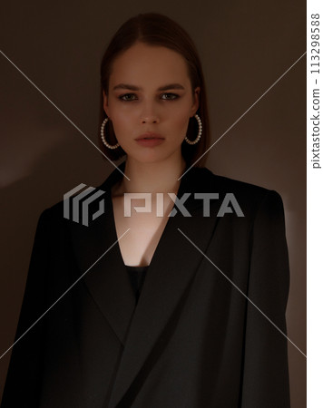 Fashionable girl model on dark grey background in 113298588