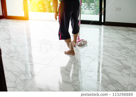 Women are mopping down the hallway to clean and rid themselves of the coronavirus disease, or COVID-19, during the holidays. Take a Close up photo Women are mopping down the hallway to clean and rid themselves of the coronavirus disease, or COVID-19, during the holidays. Take a Close up photo 113298889