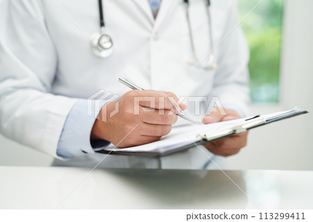Asian man doctor study document to research method and technic for treating patients. 113299411