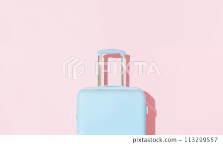 Blue suitcase on a pastel pink background with long deep shadows. Travel concept 113299557