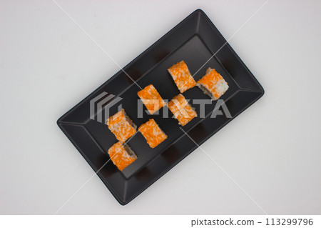 Modern Sushi Presentation on a Black Rectangular Plate 113299796
