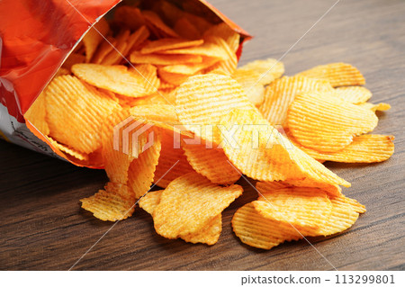Potato chips in open bag, delicious BBQ seasoning spicy for crips, thin slice deep fried snack fast food. Potato chips in open bag, delicious BBQ seasoning spicy for crips, thin slice deep fried snack fast food. 113299801