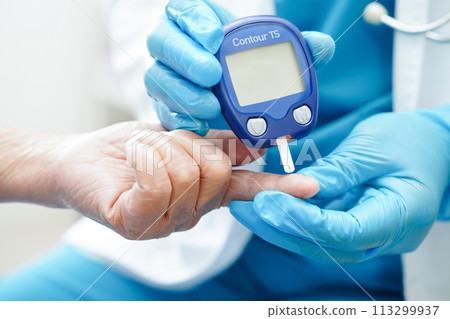 Asian doctor using digital glucose meter for check sample blood sugar level to treatment diabetes. Asian doctor using digital glucose meter for check sample blood sugar level to treatment diabetes. 113299937