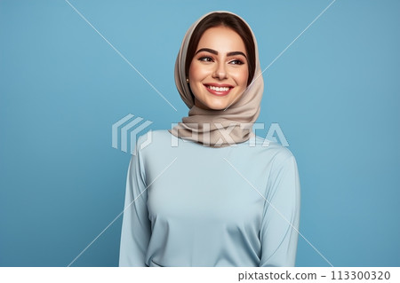 A woman wearing a blue shirt and a tan scarf is smiling 113300320