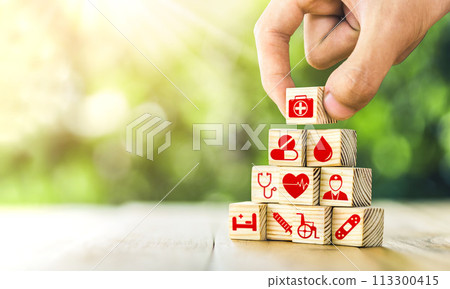 Hand arranged wooden blocks with icons of medical health. health insurance for your health concept. Healthcare medical business, medical technology equipment icon. 113300415