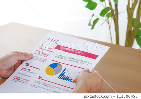 Image of considering and reviewing medical insurance and life insurance Image of considering and reviewing medical insurance and life insurance 113300455