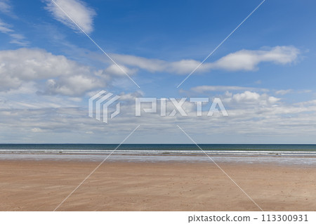 Serene St Andrews Beach in Scotland with golden sand and vast sky with clouds Serene St Andrews Beach in Scotland with golden sand and vast sky with clouds 113300931