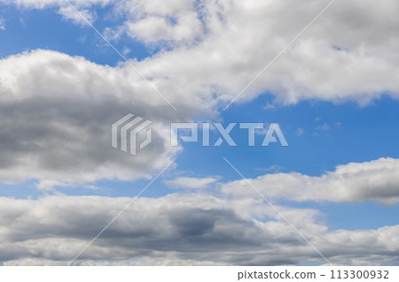 Sky unfolds in light blue, adorned with cumulus clouds for ideal backgrounds Sky unfolds in light blue, adorned with cumulus clouds for ideal backgrounds 113300932