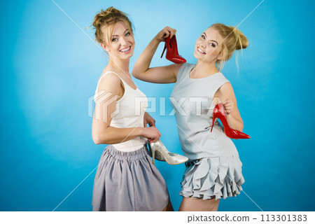 Women presenting high heels shoes Women presenting high heels shoes 113301383