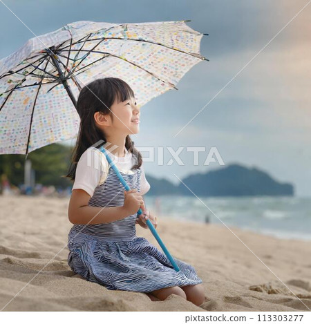 A girl looking at the sea with a parasol 113303277