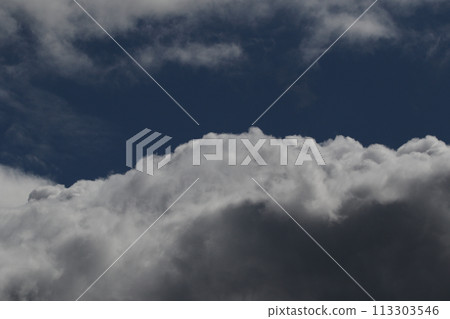 Cloudscape scenery, overcast weather above dark blue sky. Storm clouds floating in a rainy dull day with natural light. White and grey scenic environment background. Nature view. 113303546