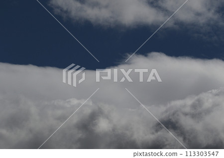 Cloudscape scenery, overcast weather above dark blue sky. Storm clouds floating in a rainy dull day with natural light. White and grey scenic environment background. Nature view. 113303547