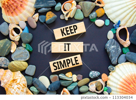 Keep it simple symbol. Concept word Keep it simple on beautiful wooden block. Sea shell stone. Beautiful black table black background. Business motivational keep it simple concept. Copy space. 113304034