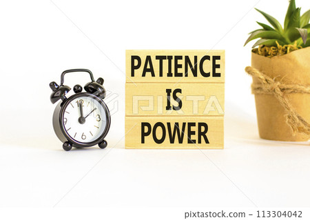 Patience is power symbol. Concept words Patience is power on beautiful wooden blocks. Beautiful white table white background. Black alarm clock. Business and patience is power concept. Copy space. 113304042