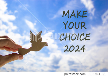 Make your choice 2024 symbol. Concept words Make your choice 2024. Beautiful blue sky cloud background. Voter hand with wooden bird. Business Make your choice 2024 concept. Copy space Make your choice 2024 symbol. Concept words Make your choice 2024. Beautiful blue sky cloud background. Voter hand with wooden bird. Business Make your choice 2024 concept. Copy space 113304135
