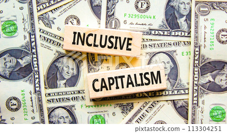 Inclusive capitalism symbol. Concept words Inclusive capitalism on beautiful wooden blocks. Dollar bills. Beautiful background from dollar bills. Business inclusive capitalism concept. Copy space. 113304251