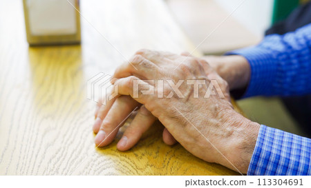 Hands of an elderly male cafe customer at a table waiting Hands of an elderly male cafe customer at a table waiting 113304691