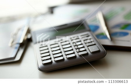 Silver calculator with gray keyboard is lying Silver calculator with gray keyboard is lying 113306613