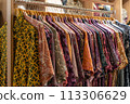 Various types of batik shirts for sale in the retail shop. 113306629