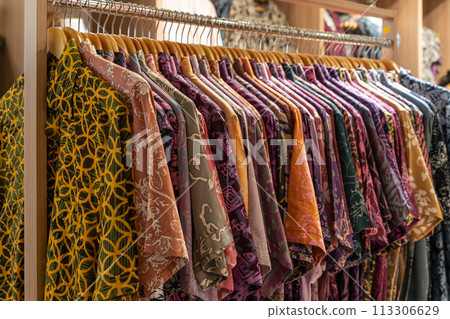 Various types of batik shirts for sale in the retail shop. Various types of batik shirts for sale in the retail shop. 113306629