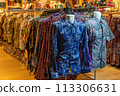 Various types of batik shirts for sale in the retail shop. 113306631