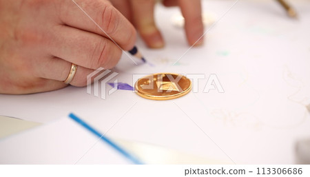Golden ethereum coin lying at table closeup Golden ethereum coin lying at table closeup 113306686