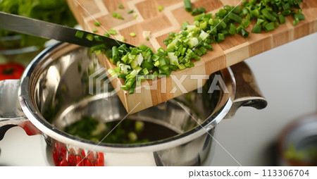 Cook holds knife in hand and cuts on Cook holds knife in hand and cuts on 113306704