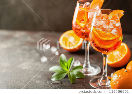 Two glasses of Aperol Spritz with ice on a table Two glasses of Aperol Spritz with ice on a table 113306901
