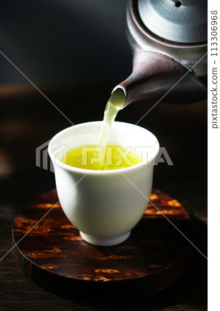 Green tea poured from a teapot Green tea poured from a teapot 113306968