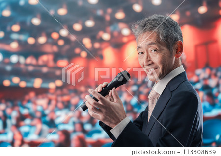 Man speaking in front of a large audience Man speaking in front of a large audience 113308639