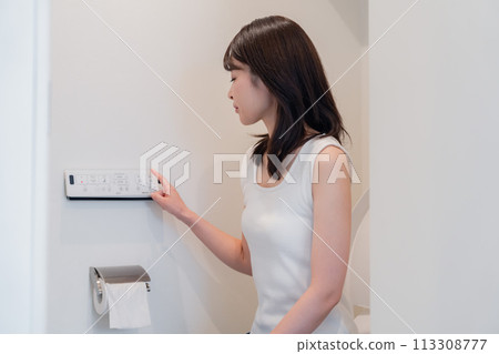 Young woman using a bidet 113308777