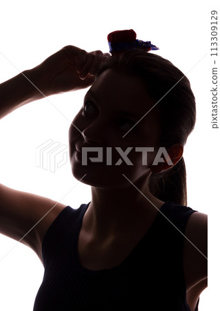 Young woman in hat looking up - vertical silhouette Young woman in hat looking up - vertical silhouette 113309129