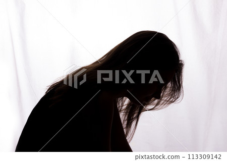Silhouette of a young woman with problems 113309142