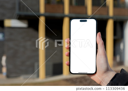 Berlin Germany January 21 2024 Hand holding mobile phone, iphone screen mockup, white smartphone 113309436
