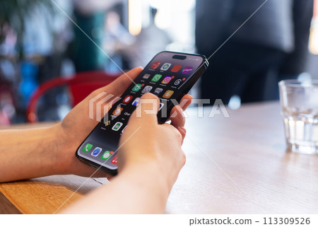 Berlin Germany January 21 2024 Hand uses mobile phone, iphone smartphone, screen with application 113309526